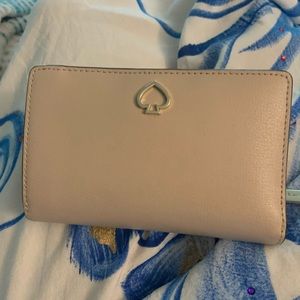 Medium bifold wallet in blush by Kate Spade